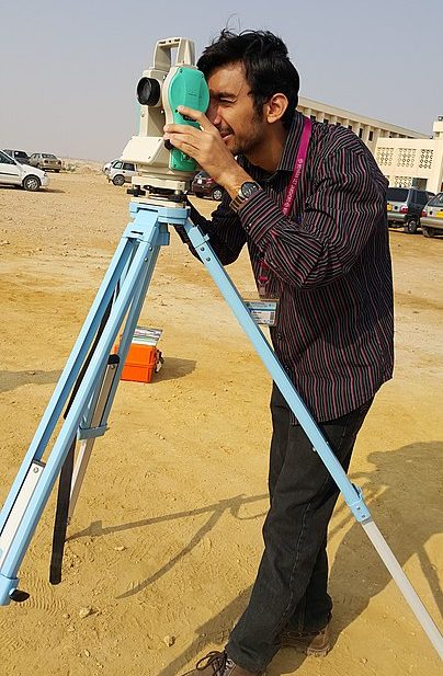 Surveyor using Theodolite in field